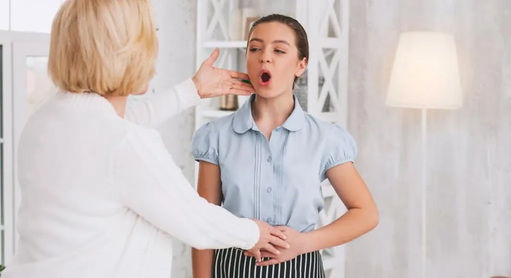Voice teacher guiding a student's breathing with a hand on her belly