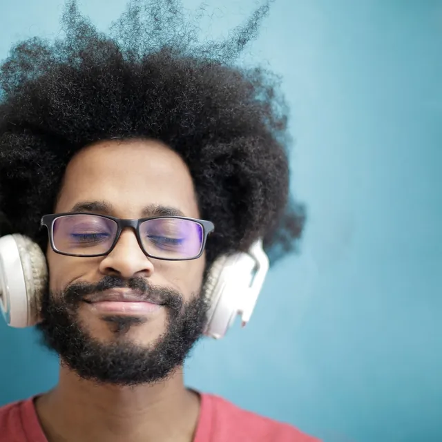 Man in white headphones listening with his eyes closed